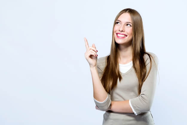 Beautiful young woman pointing at the plastic surgery promotion.