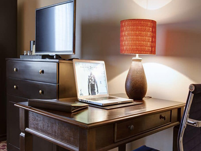 Picture of a table, chair, lamp and TV at the Costa Rica Medical Center Inn, San Jose, Costa Rica.